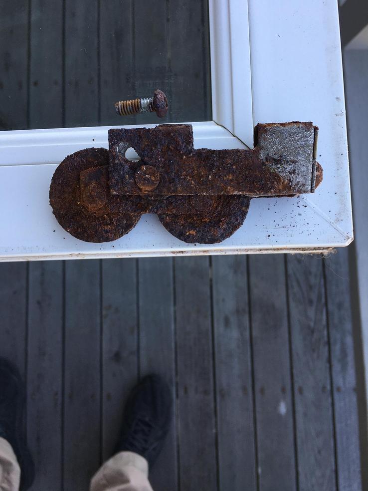Rusted roller in a door by the beach